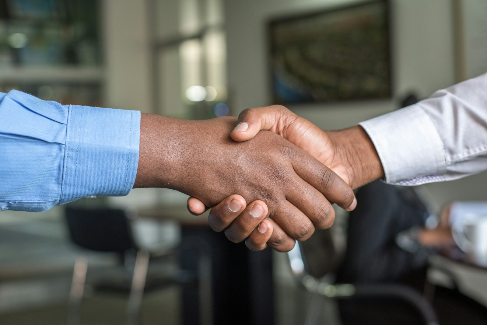 Business handshake between importer and sourcing agent after supplier verification