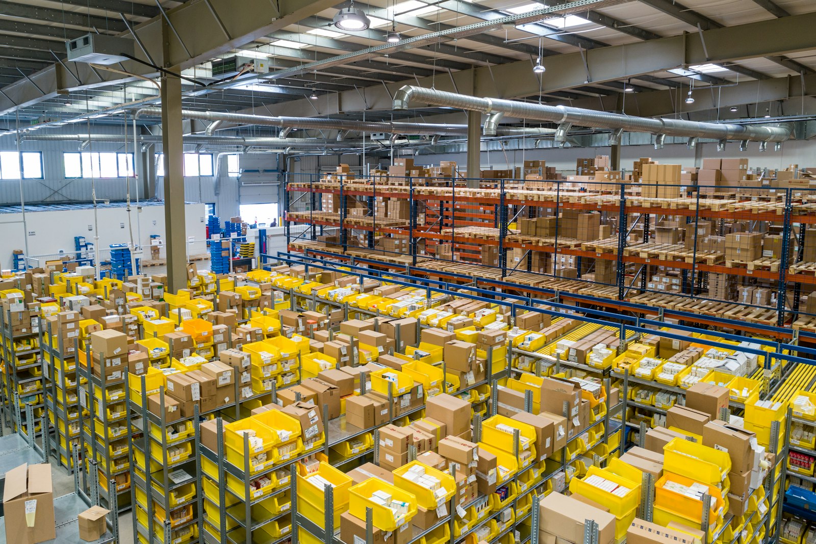 Warehouse worker moving palletised goods for export orders